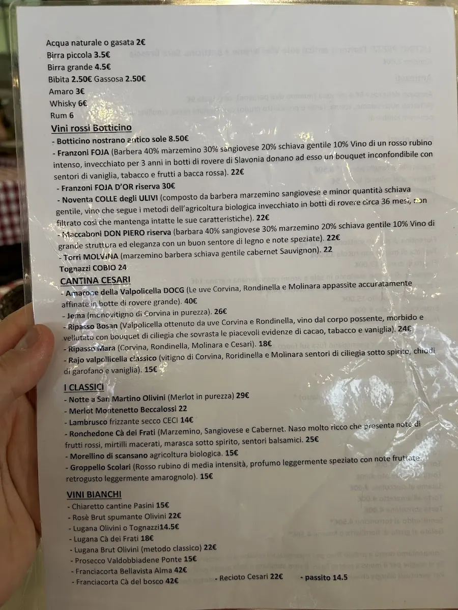 Dettaglio della sala della Trattoria Antico Sole - mani che lavorano in cucina bresciana